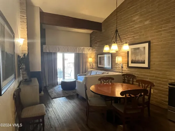 a dining room with furniture and window