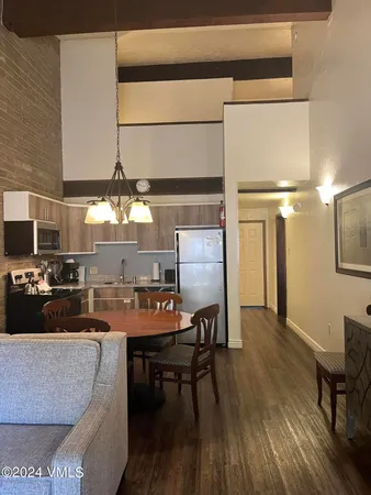 a dining room with furniture and wooden floor