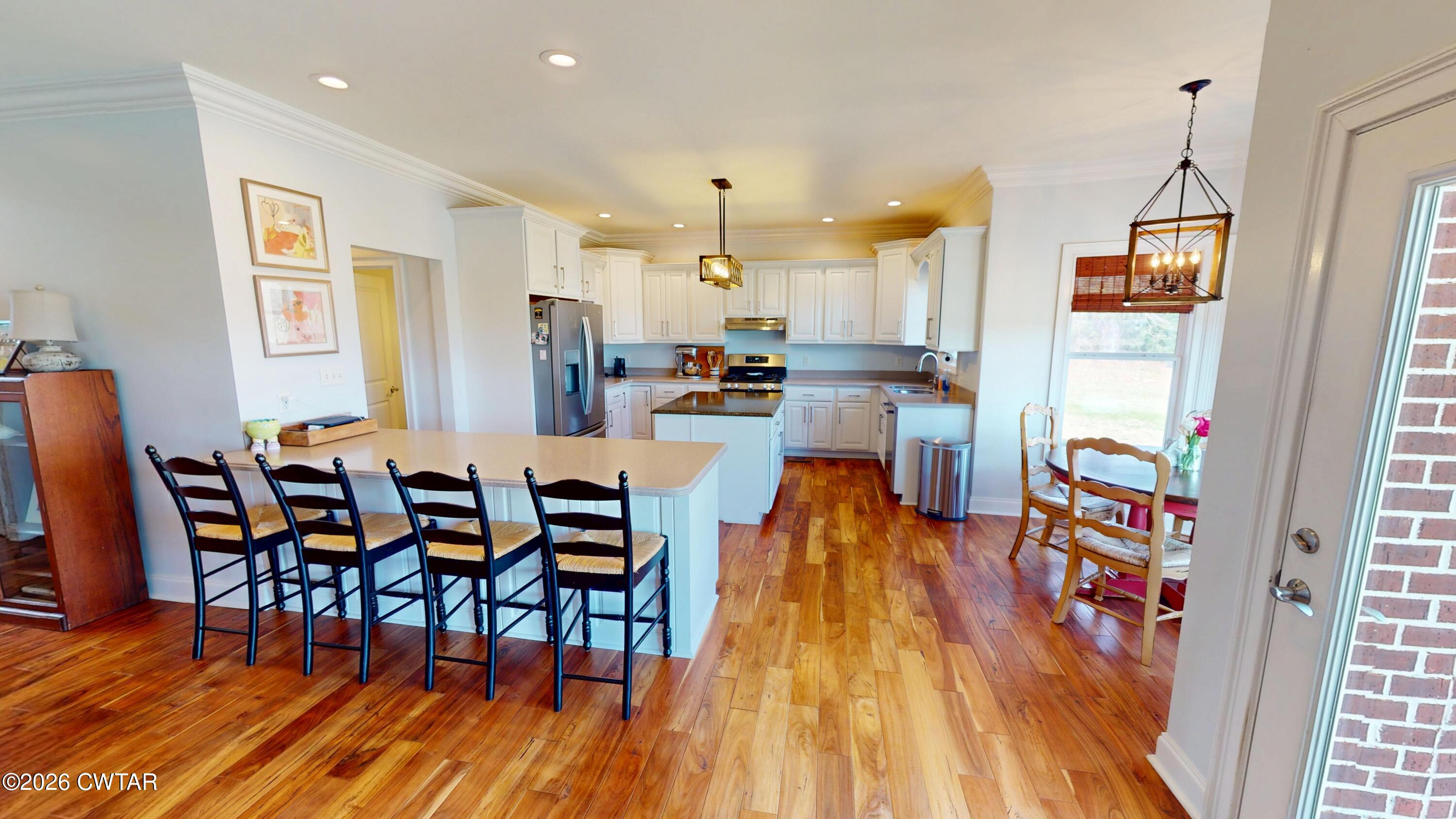 740 Gordon Road Dyersburg, TN 38024 - Photo 15 of 48 a view of a dining room with furniture and wooden floor