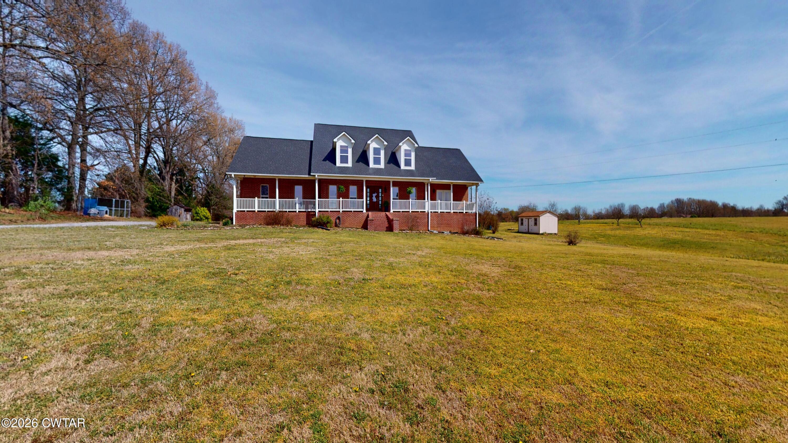 740 Gordon Road Dyersburg, TN 38024 - Photo 2 of 48 a view of a house with a big yard and large trees