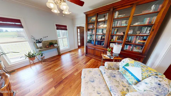 a living room with furniture and a book shelf