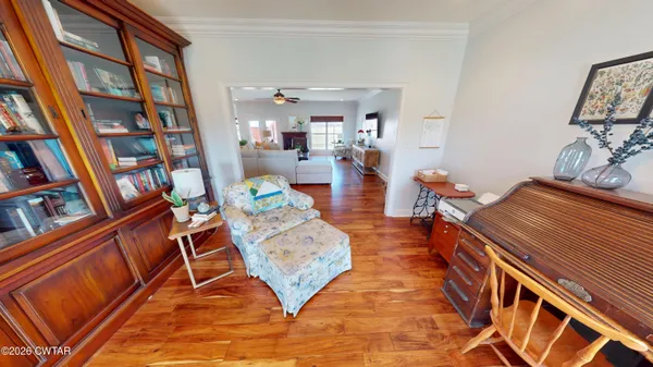 a living room with furniture and a book shelf