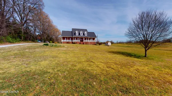 a yellow building with trees in front of it