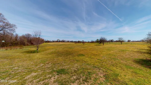an aerial view of a house with backyard