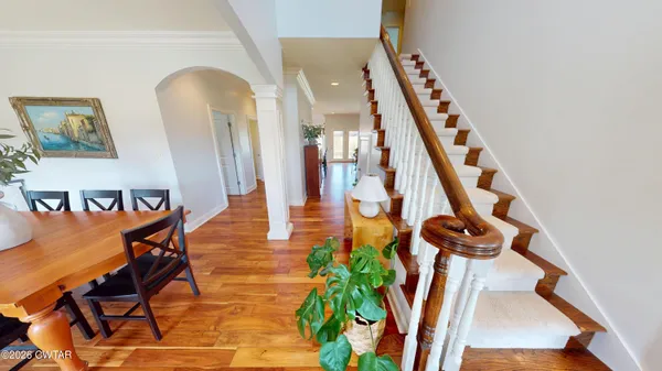 a view of an entryway with wooden floor