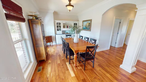 a view of a dining room with furniture and wooden floor