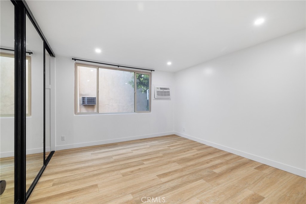 17000 Burbank Boulevard, Unit 101 Encino, CA 91316 - Photo 11 of 24 a view of empty room with wooden floor and fan