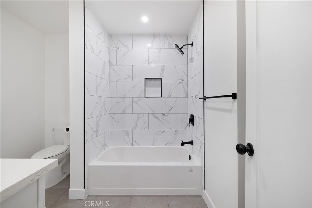 17000 Burbank Boulevard, Unit 101 Encino, CA 91316 - Photo 15 of 24 a bathroom with a bathtub and a shower