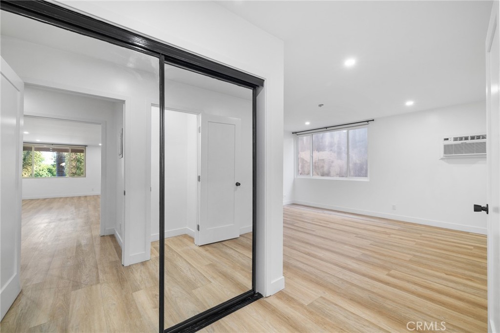 17000 Burbank Boulevard, Unit 101 Encino, CA 91316 - Photo 17 of 24 a view of a hallway with wooden floor and a living room
