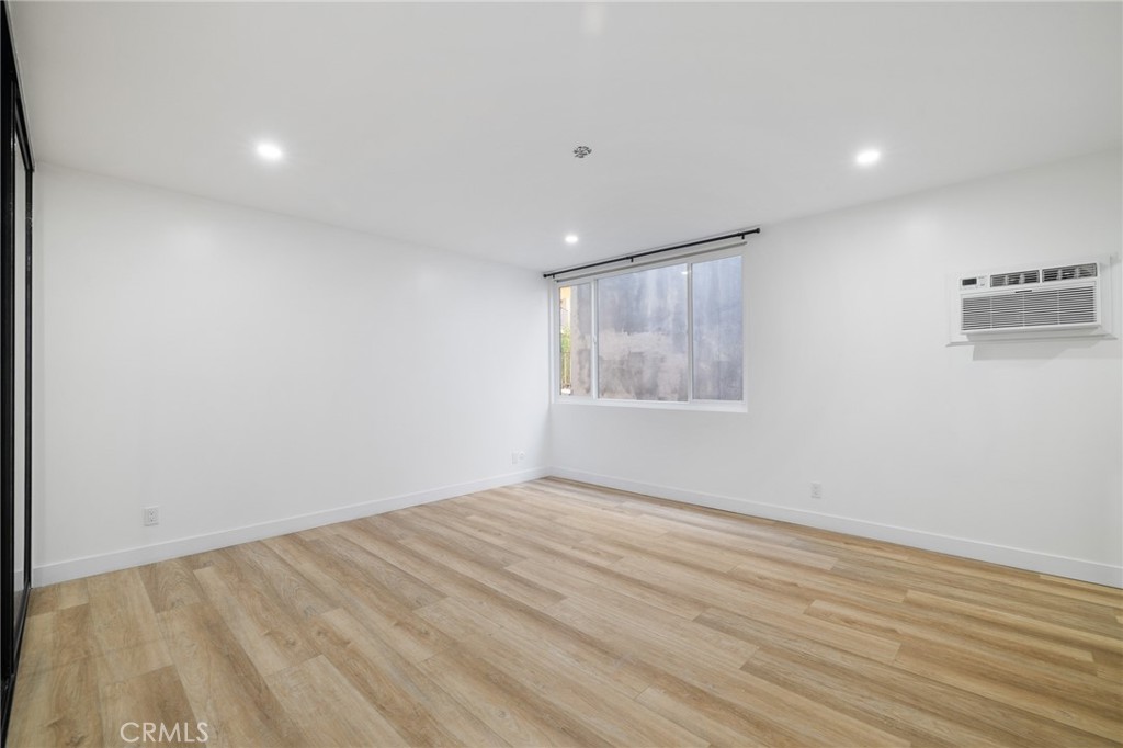17000 Burbank Boulevard, Unit 101 Encino, CA 91316 - Photo 18 of 24 wooden floor in an empty room with a window