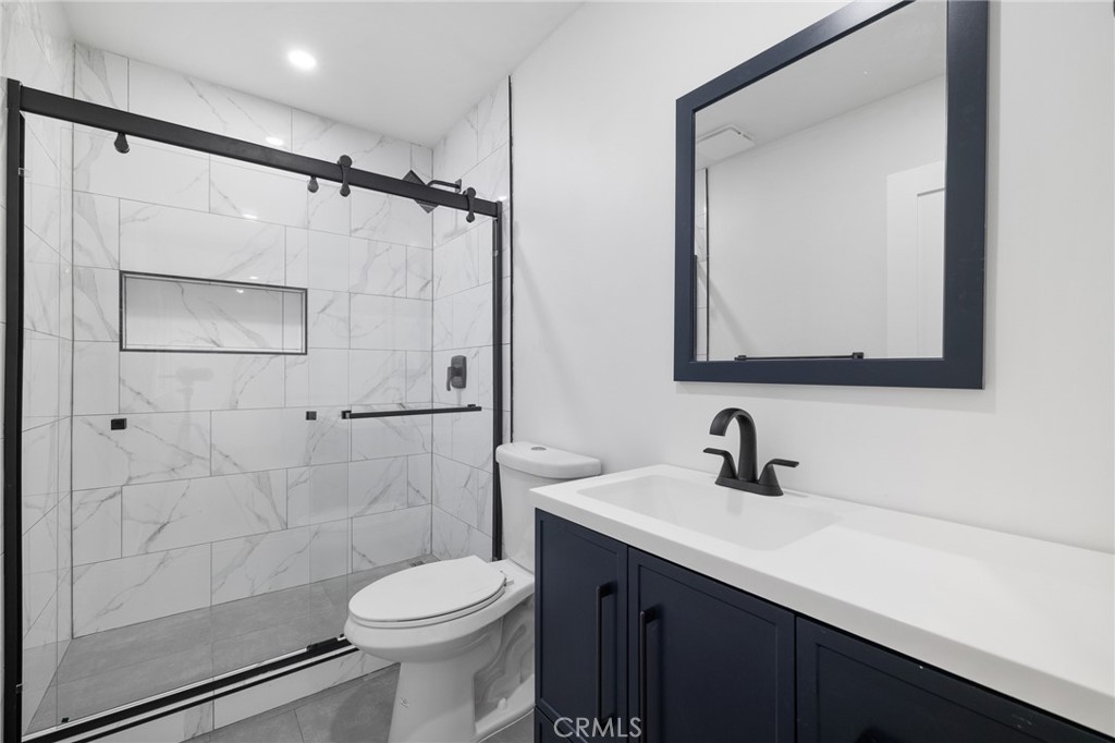 17000 Burbank Boulevard, Unit 101 Encino, CA 91316 - Photo 21 of 24 a bathroom with a sink toilet and shower