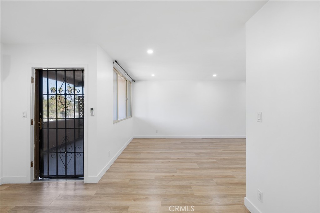 17000 Burbank Boulevard, Unit 101 Encino, CA 91316 - Photo 4 of 24 a view of hallway with wooden floor and stairs