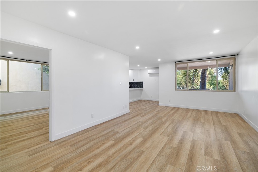 17000 Burbank Boulevard, Unit 101 Encino, CA 91316 - Photo 7 of 24 wooden floor in an empty room with a window