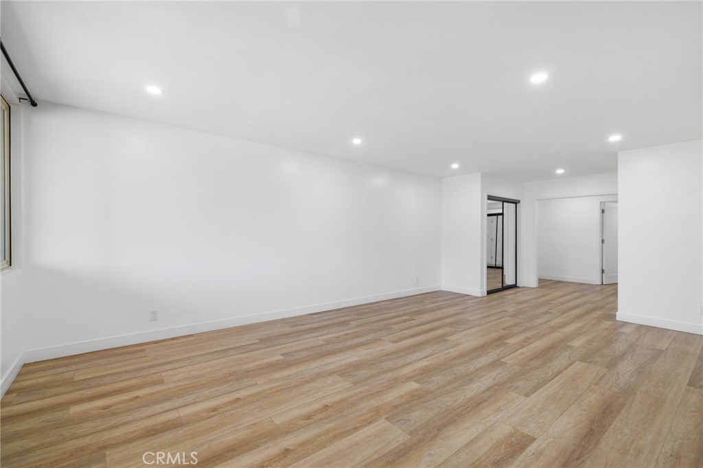 17000 Burbank Boulevard, Unit 101 Encino, CA 91316 - Photo 9 of 24 a view of an empty room with wooden floor