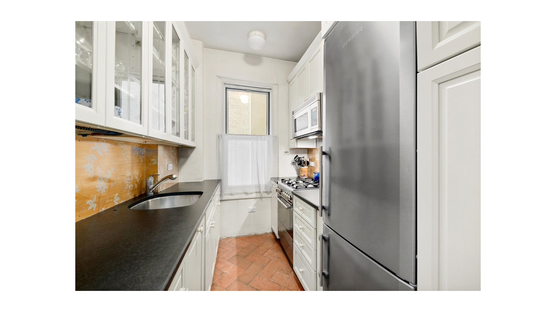 155 East 73rd Street, Unit 1D Manhattan, NY 10021 - Photo 3 of 7 a hallway with a view of living room with a sink