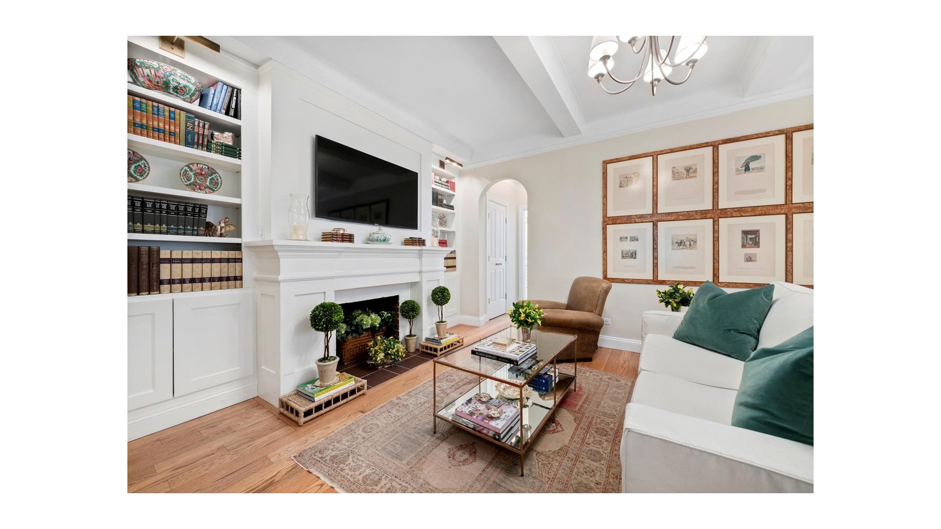 155 East 73rd Street, Unit 1D Manhattan, NY 10021 - Photo 4 of 7 a living room with furniture a flat screen tv and a fireplace