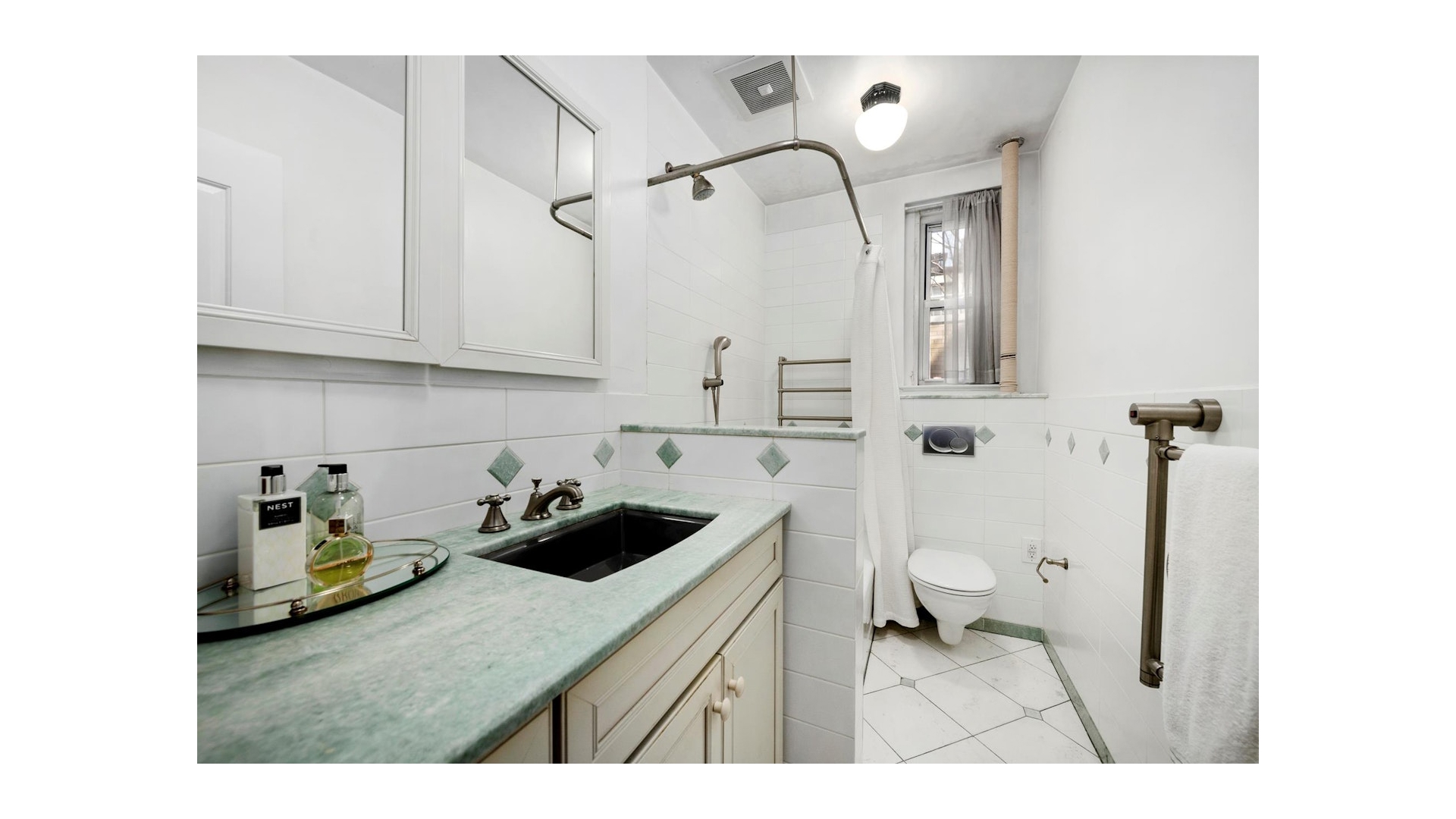 155 East 73rd Street, Unit 1D Manhattan, NY 10021 - Photo 5 of 7 a bathroom with a sink and a toilet