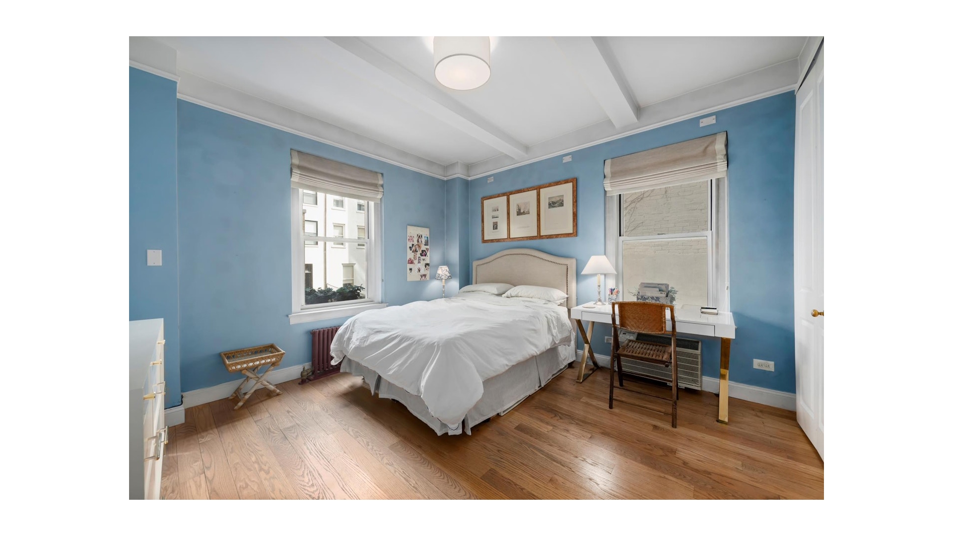 155 East 73rd Street, Unit 1D Manhattan, NY 10021 - Photo 6 of 7 a bedroom with a bed window and a table