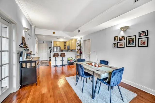 a view of a dining room with furniture and wooden floor