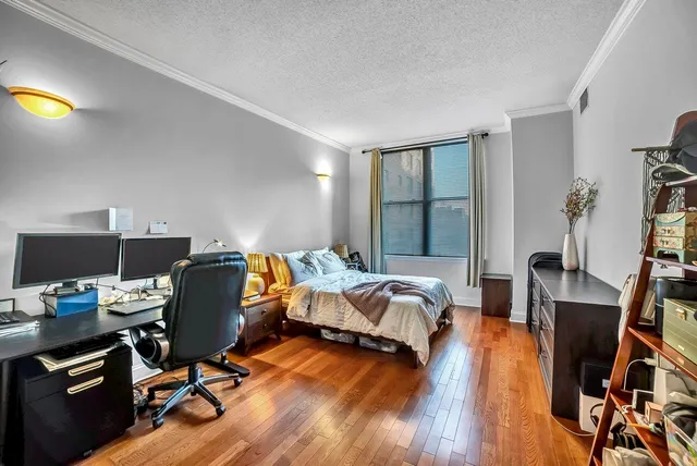 a bedroom with furniture and a wooden floor