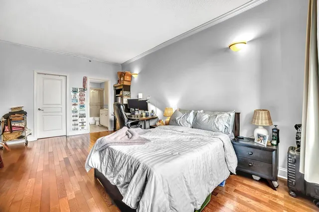 a bed room with a bed and a book shelf