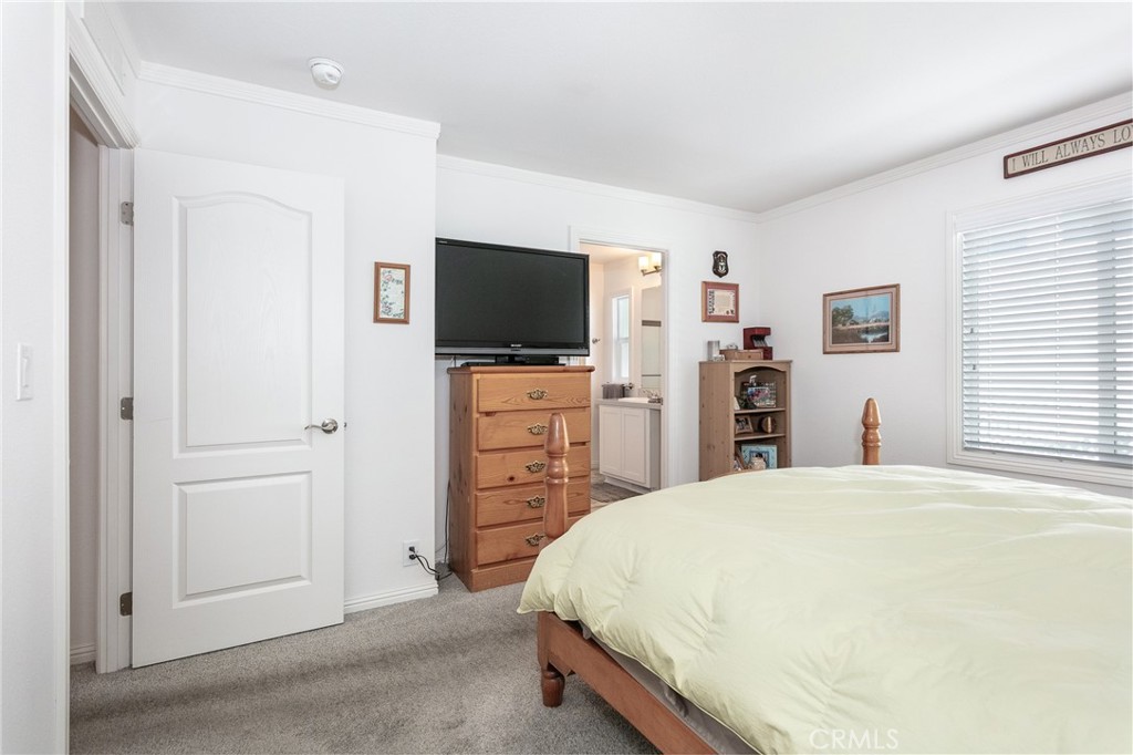 18 Portola Road San Fernando, CA 91345 - Photo 16 of 21 a bedroom with a bed and a flat screen tv