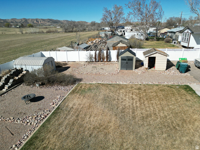 1852 East 3500th Street South Vernal, UT 84078 - Photo 41 of 46 Fenced backyard featuring sheds and a residential view