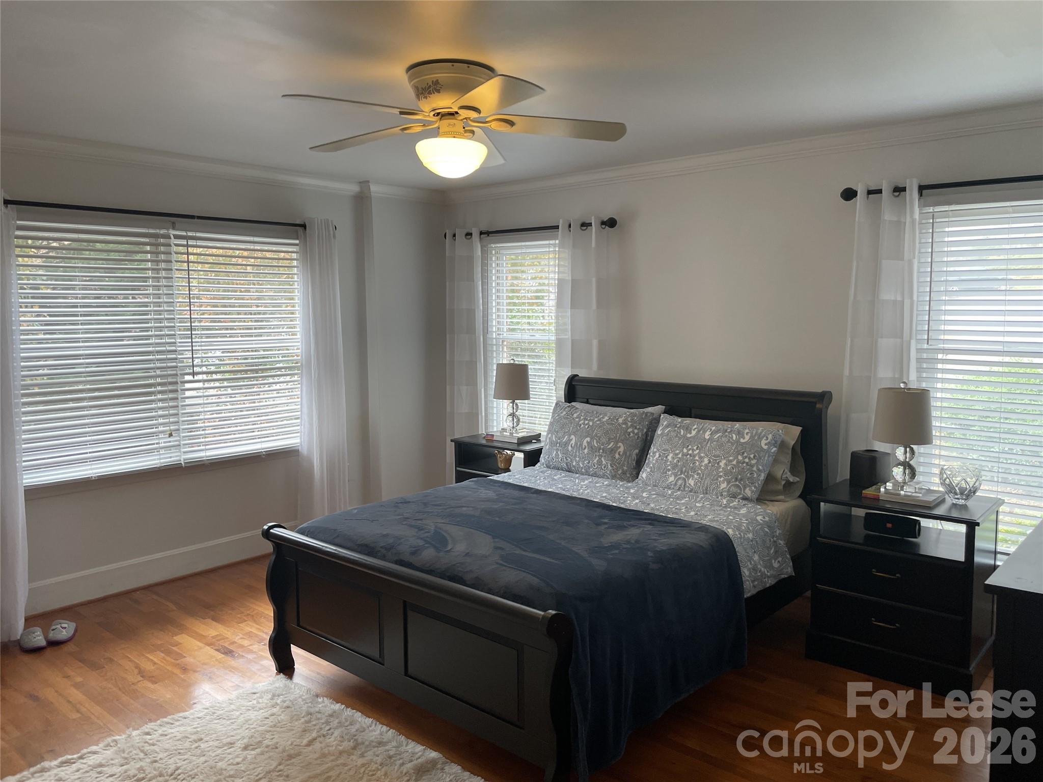 3800 Oldfield Road Charlotte, NC 28226 - Photo 21 of 32 a bedroom with a bed and a chandelier