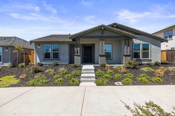 a view of a front of house with a small yard