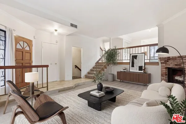 a living room with furniture fireplace and rug