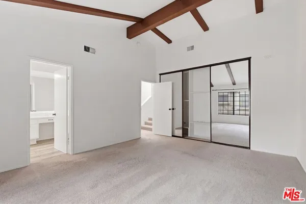 a view of an empty room with a ceiling fan