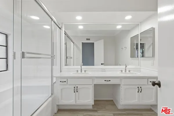 a bathroom with a double vanity sink mirror and double