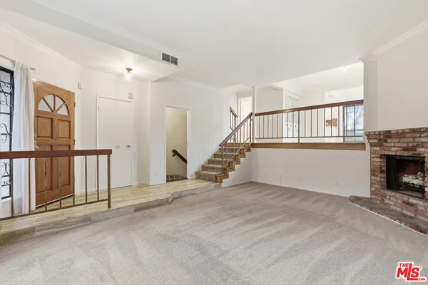 a view of an empty room with stairs
