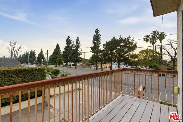 a balcony with wooden floor and fence
