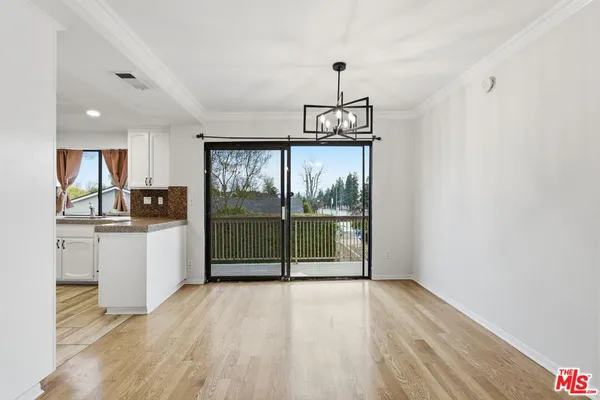 a view of a kitchen with a sink and dishwasher a refrigerator with wooden floor