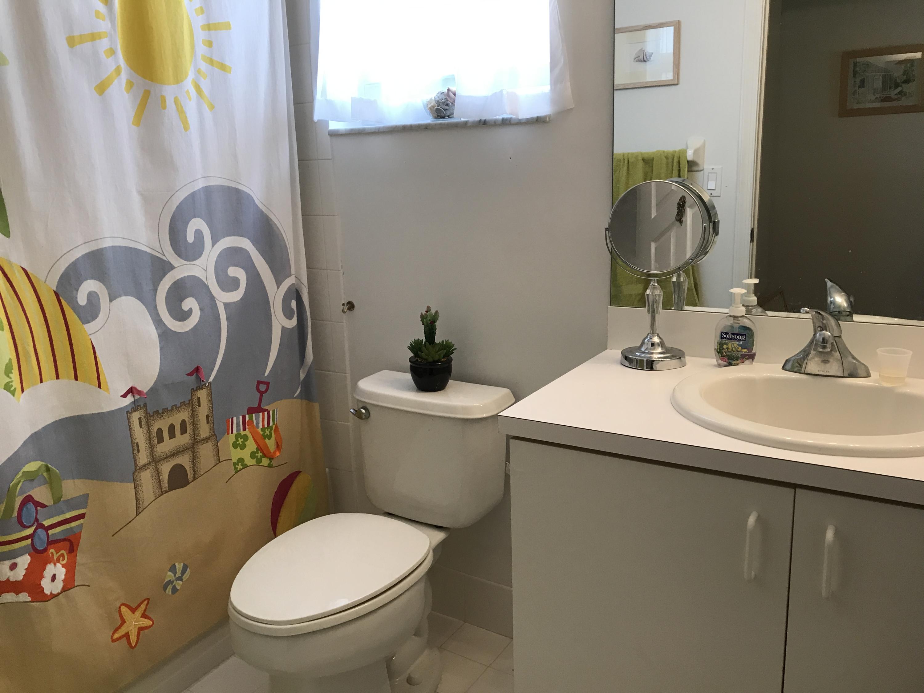 15290 Lake Wildflower Road Delray Beach, FL 33484 - Photo 17 of 22 a bathroom with a toilet sink and mirror