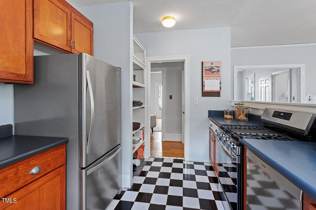 628 East Franklin Street Raleigh, NC 27604 - Photo 19 of 37 a kitchen with stainless steel appliances granite countertop a refrigerator and a stove top oven