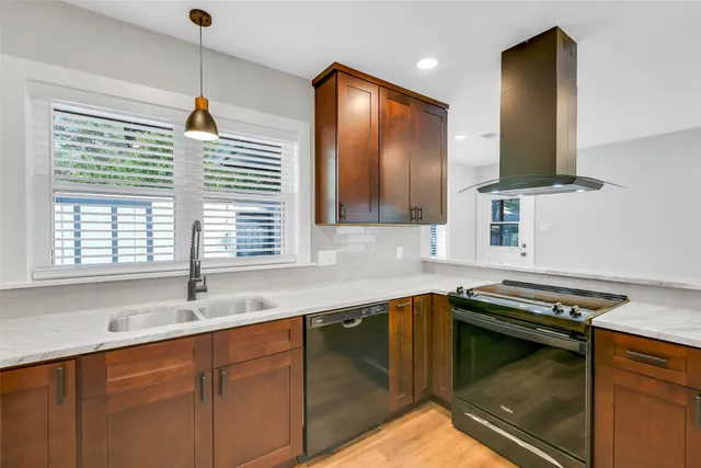 a kitchen with a sink stove and microwave