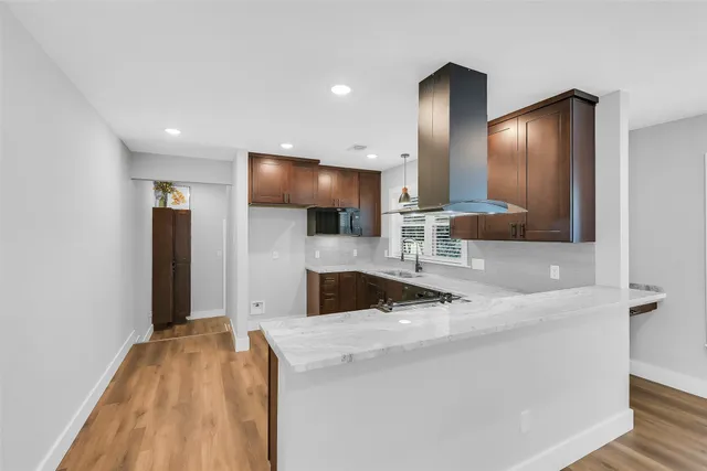 a view of a kitchen with a sink and a large mirror