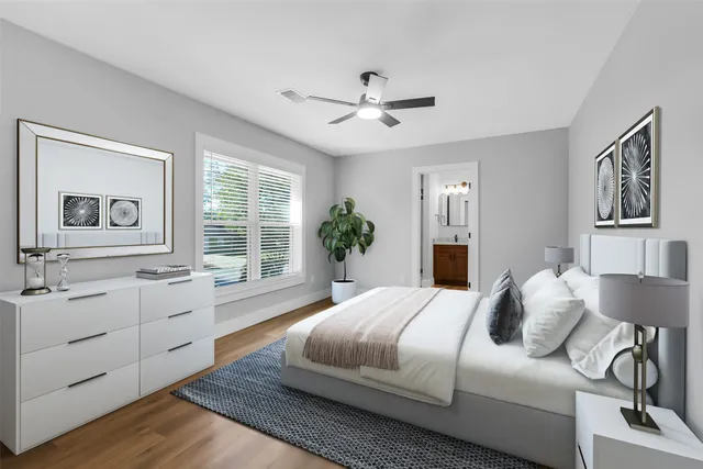 a bedroom with a large bed and a chandelier