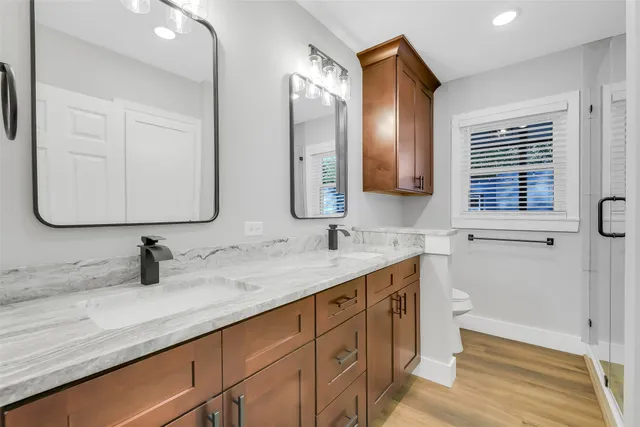 a bathroom with a double vanity sink and mirror