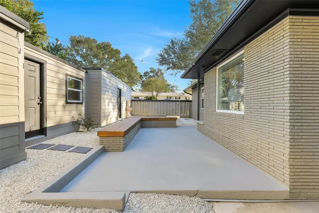 a view of a house with backyard and sitting area