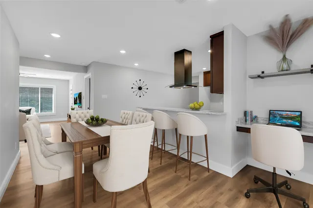 a view of a dining room with furniture and wooden floor