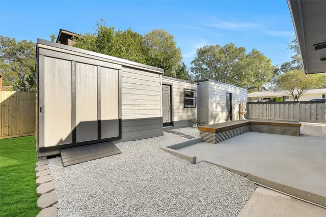 a view of a house with backyard and sitting area