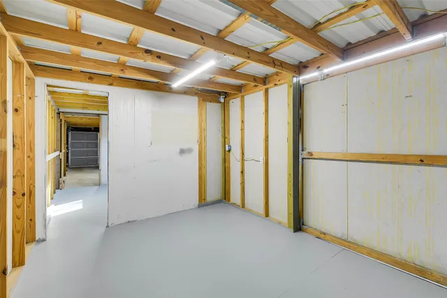 a view of a hallway with wooden shelves