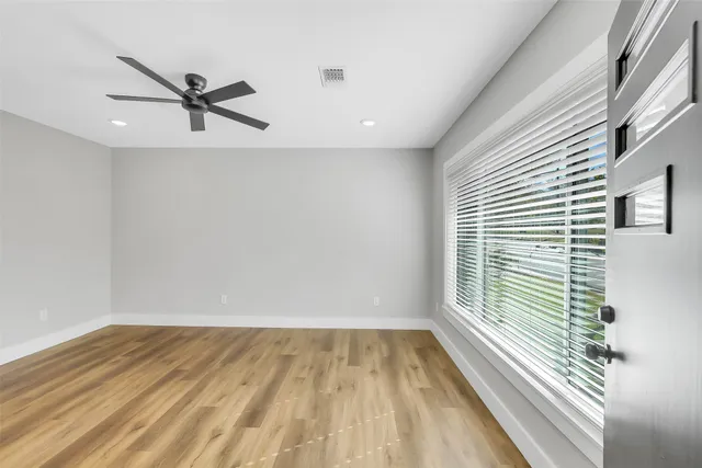 a view of a room with wooden floor and a window