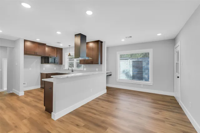 a large kitchen with stainless steel appliances granite countertop a stove a sink and a large refrigerator