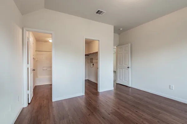 a view of a hallway with wooden floor