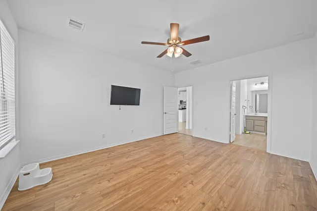 a bathroom with a tub sink shower and mirror