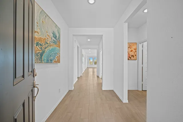 a view of hallway with wooden floor